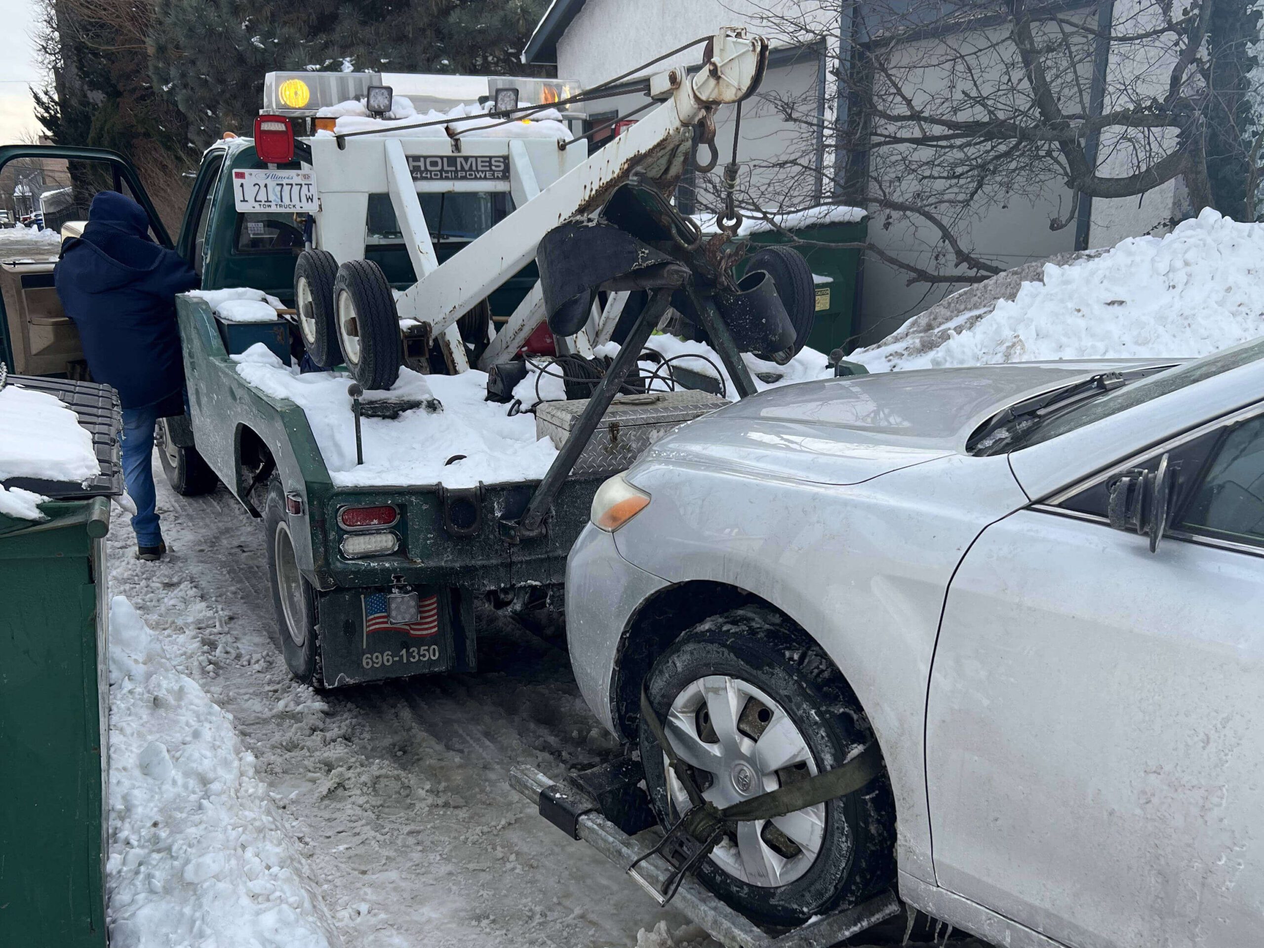 Rick's Emergency Roadside Assistance Assisting car in snow - Rick's Emergency Roadside Assistance