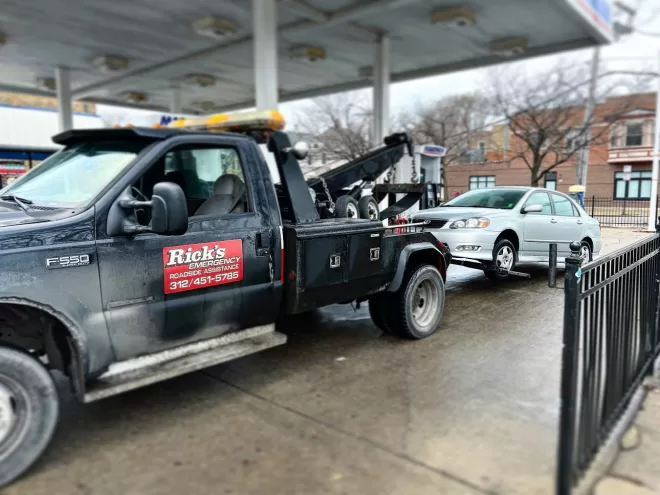 Tow truck safely delivering a vehicle to a mechanic shop, showcasing our efficient and damage-free towing services for quick and easy vehicle handling.
