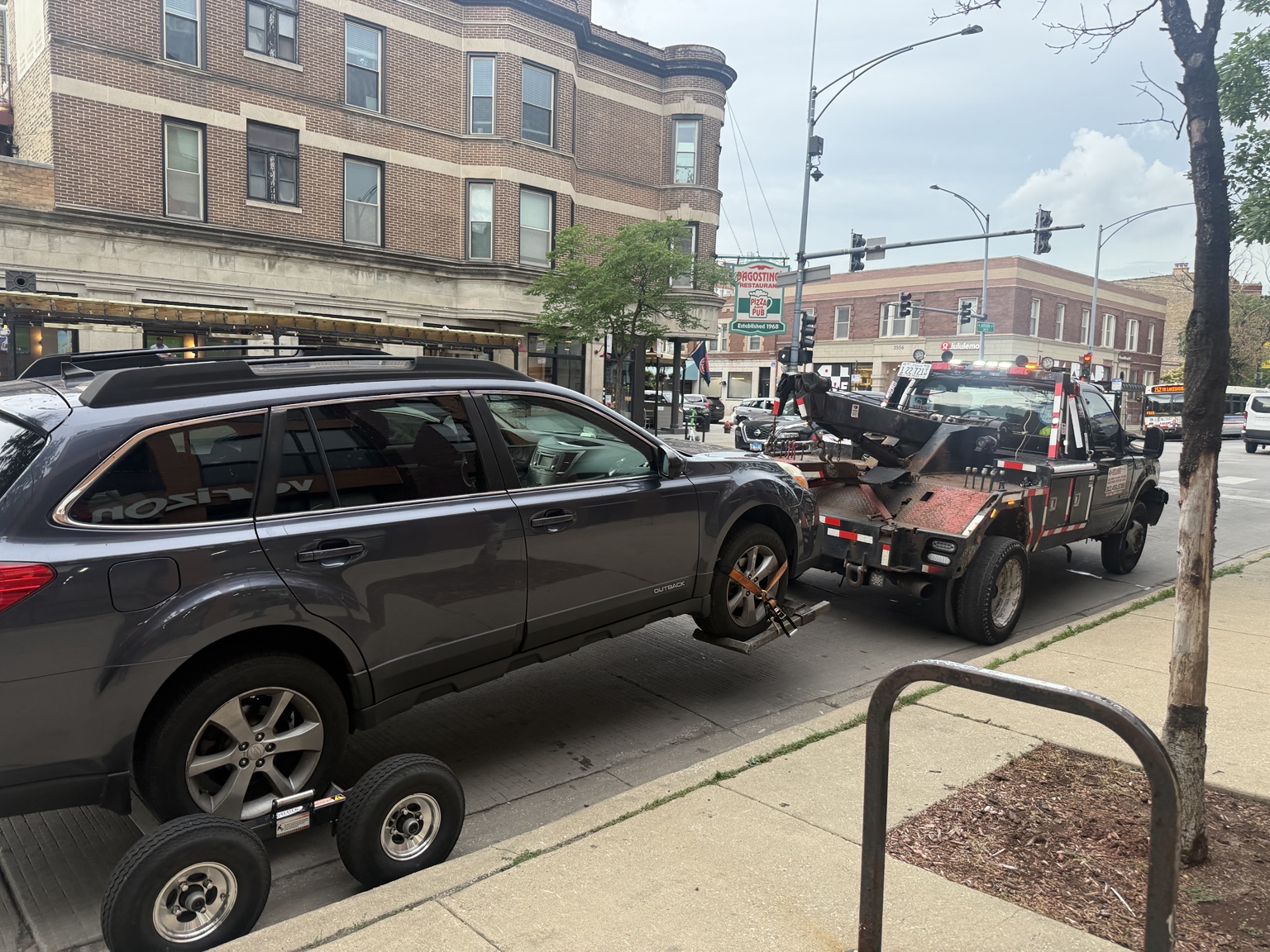 AWD Subaru Outback being towed after overheating near Addison and Southport in Wrigleyville Chicago