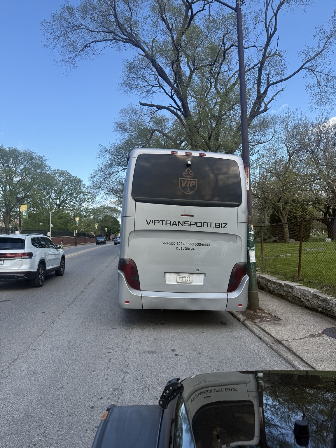 Coach bus receiving an emergency commercial jump start near Clark Street and Irving Park Road by Graceland Cemetery in Chicago