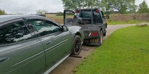 Car being wheel-lift towed after electrical issues inside Montrose Cemetery in Chicago