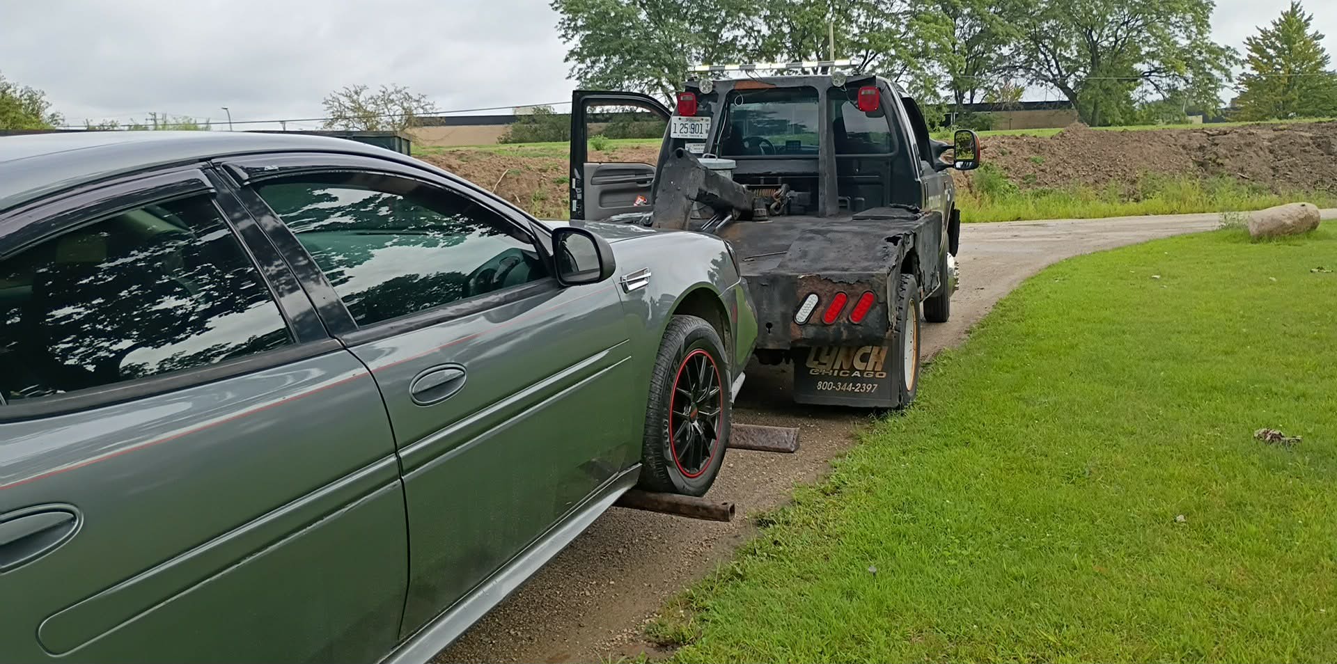 Car being wheel-lift towed after electrical issues inside Montrose Cemetery in Chicago
