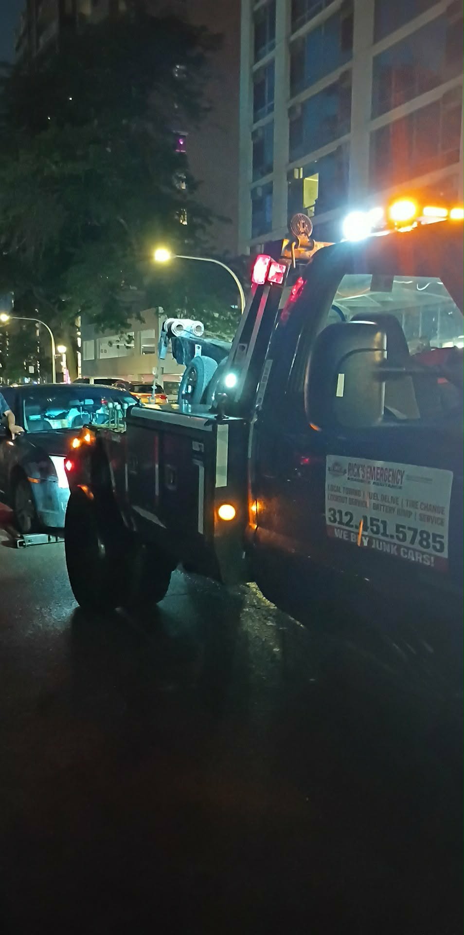 Alternate view of Rick’s wheel-lift tow truck during a nighttime towing call on Chicago’s North Side
