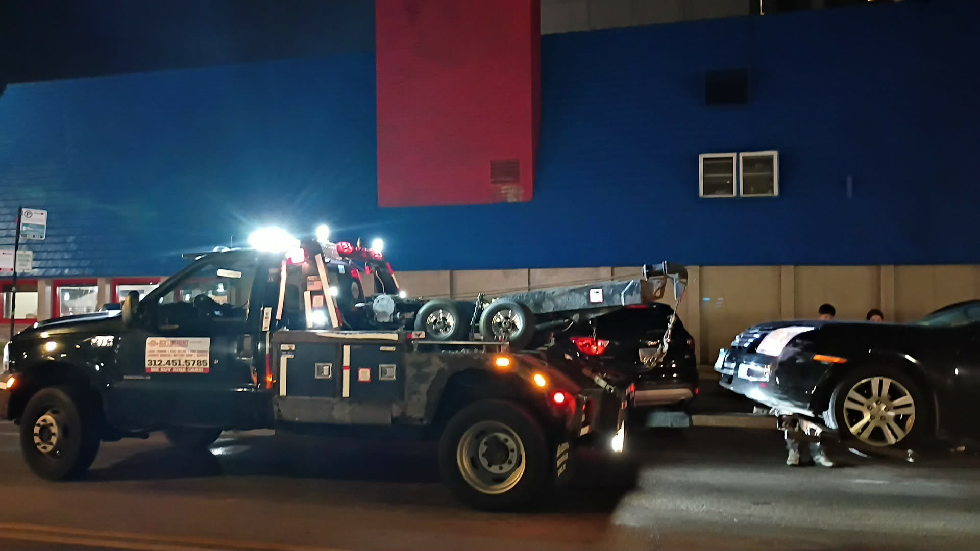 Rick’s wheel-lift tow truck providing nighttime towing on Chicago’s North Side