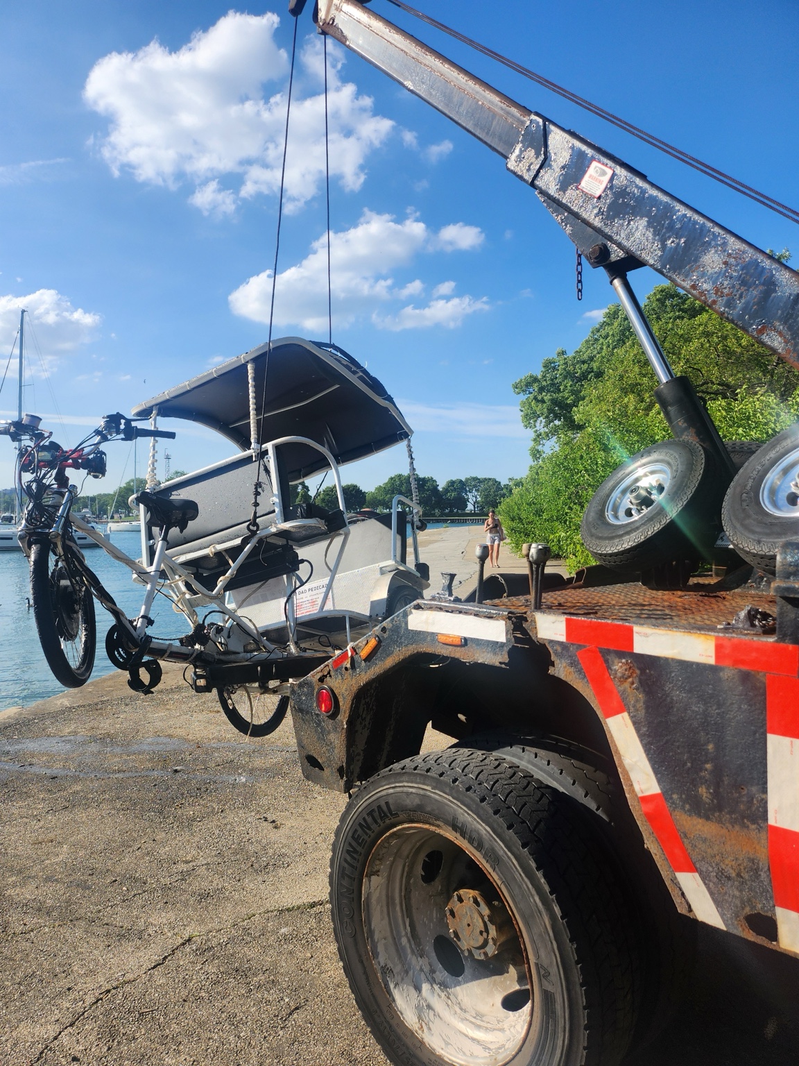 Pedicab being lifted from Diversey Harbor during a recovery job in Lincoln Park Chicago