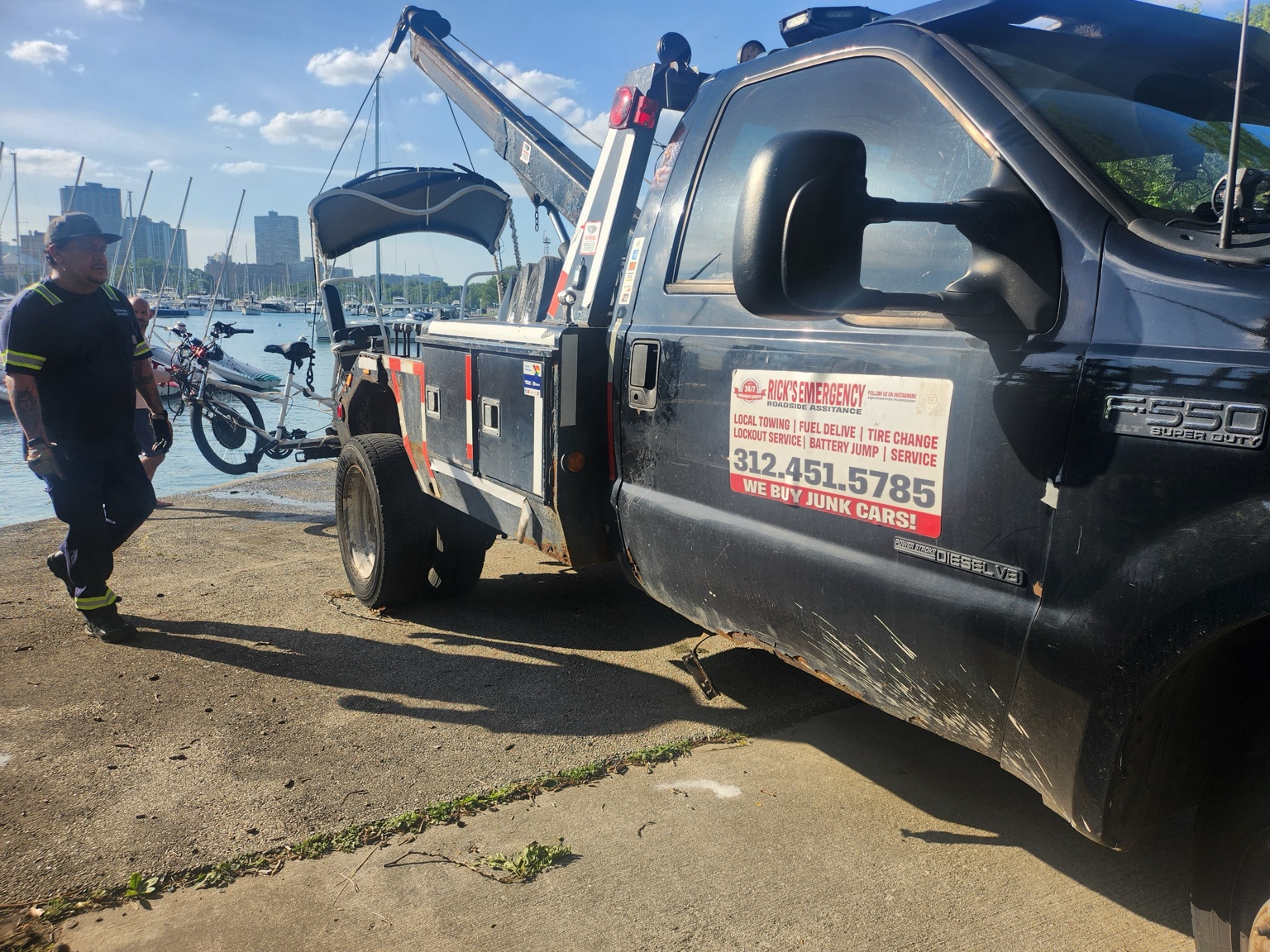 Rick’s tow truck recovering a pedicab from the water at Diversey Harbor in Chicago