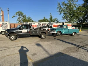 Black and green tow trucks parked together.