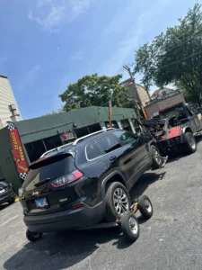 Black suv on towing dollies.