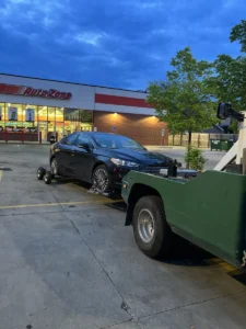 Blue sedan wheel lift at autozone.