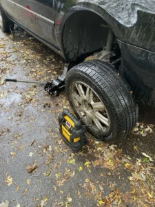 Removed sedan wheel with tire inflator.