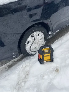 Snow covered wheel with portable inflator.