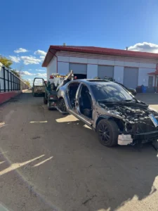 Wheel lift truck with damaged vehicle.