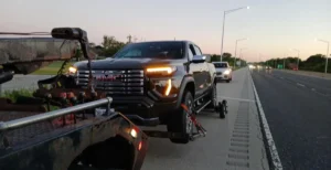 White gmc pickup wheel lift and dollies.