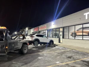 White suv dolly tow outside nissan service.
